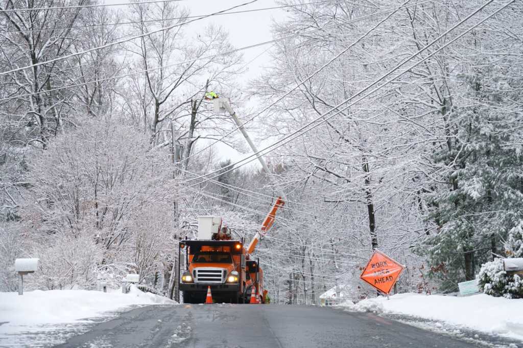 manual worker working on repair electrical line after winter snow storm HFG Trust